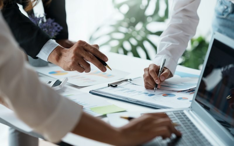 business-people-pointing-to-graph-and-chart-to-analyze-market-sale-balance-sheet-account-net-pro.jpg